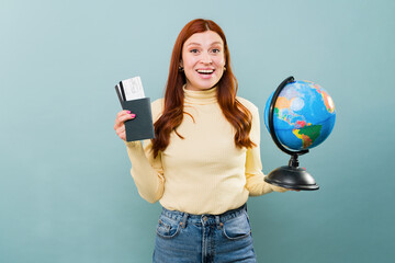 Excited attractive woman with red hair ready to travel
