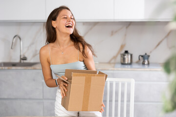 She signs for package and offers a friendly smile, appreciating timely delivery.