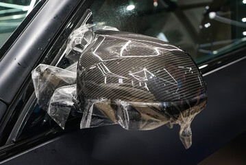 The process of installing PPF on the side mirror. Car wrapping close-up. Car wrapping. A car...