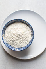 All purpose flour in a blue bowl, baking flour in a large bowl