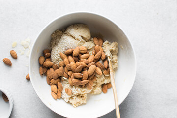 overhead view of almond biscotti dough in a white bowl, almond cantucci cookie dough in ceramic mixing bowl, flatlay of biscotti cookie dough or twice baked cookies
