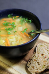 Vegetarian yellow peas soup in bowl with slices of olive bread