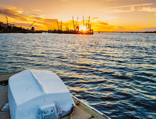 Dinghy on Pier With Shrimp Boats on The Amelia River at Sunset, Fernandina City, Amelia Island,...