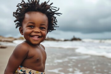 Portrait of a cute african american baby boy on the beach - obrazy, fototapety, plakaty