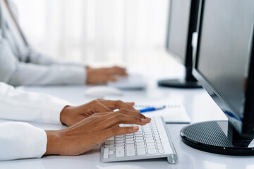 Close up shot of woman hands using desktop computer for crucial office working