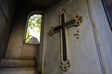 christian cross in a cemetery mausoleum