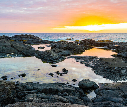 Clouds Reflection in Tide Pools on The Volcanic Shoreline of OTEC Beach, Hawaii Island, Hawaii, USA