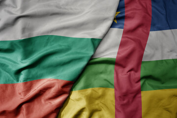 big waving national colorful flag of central african republic and national flag of bulgaria .
