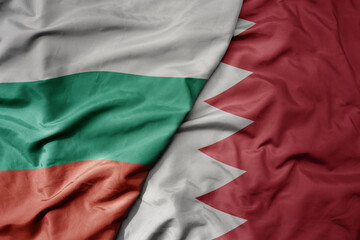 big waving national colorful flag of bahrain and national flag of bulgaria .