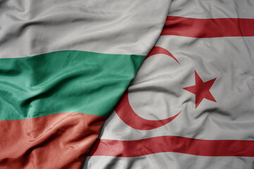 big waving national colorful flag of northern cyprus and national flag of bulgaria .