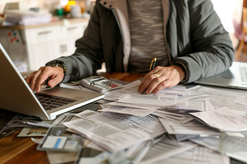 Person Paying Bills or Filing Tax Return at Desk at Home, Past Due Bills Pilling Up