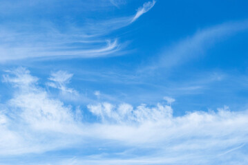 delicate patterns of white clouds in the blue sky