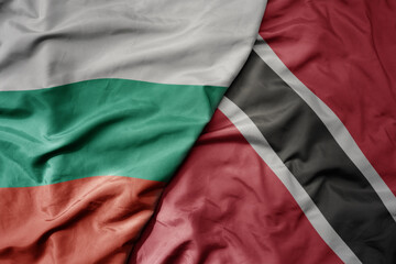big waving national colorful flag of trinidad and tobago and national flag of bulgaria .