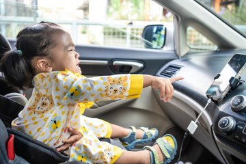 Little girl enjoying sit on car seat fasten belt - 740364620