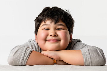 Obraz premium Studio portrait of smiling overweight young boy.