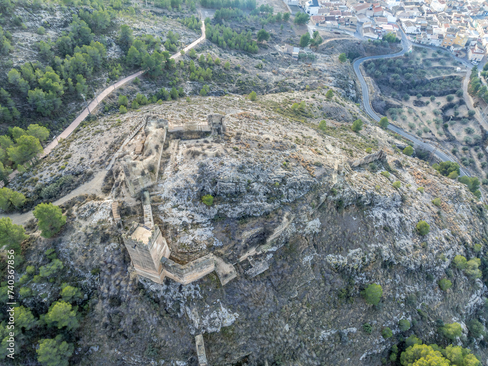 Sticker aerial view of medieval pliego castle partially restored curtain walls, square tower on a hilltop in