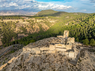 Fototapeta na wymiar Aerial view of Pliego town and medieval castle in Southern Spain, ruined walls made of rammed earth with Arab origin
