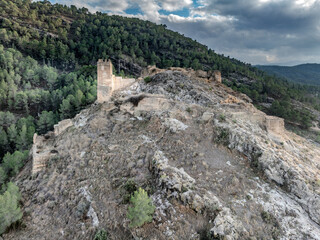 Aerial view of Pliego town and medieval castle in Southern Spain, ruined walls made of rammed earth with Arab origin