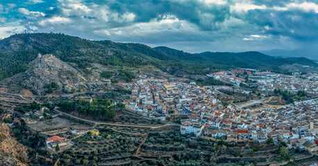 Aerial view of Pliego town and medieval castle in Southern Spain, ruined walls made of rammed earth...