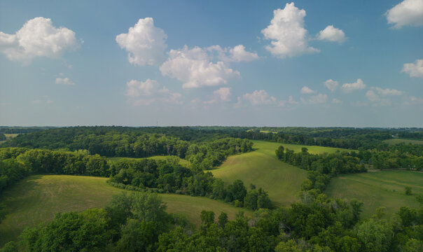 Eastern Iowa's rolling landscape inspired the painter Grant Wood. The beautiful hills are dotted with trees that add lines and texture to the landscape. The fluffy white clouds add depth and dimension