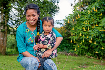 An authentic smile of a young mother next to her small and beautiful daughter, shows her happy life...