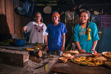 Portrait of 3 beautiful Latin women cooking tamales