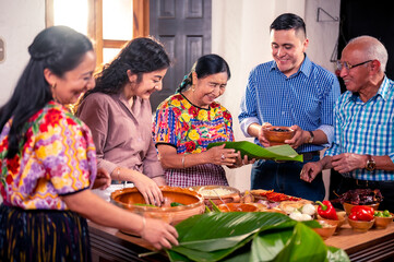 The family enjoys the gathering during the preparation of corn dough tamales.