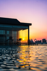 Infinity swimming pool in the resort at sunset