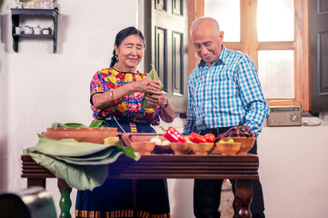 Portrait of senior adults cooking tamales, a traditional Latin American dish.