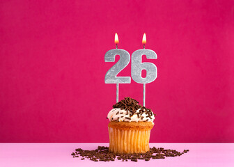 Birthday cupcake with candle number 26 - Birthday card on pink background