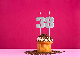 Birthday cupcake with candle number 38 - Birthday card on pink background