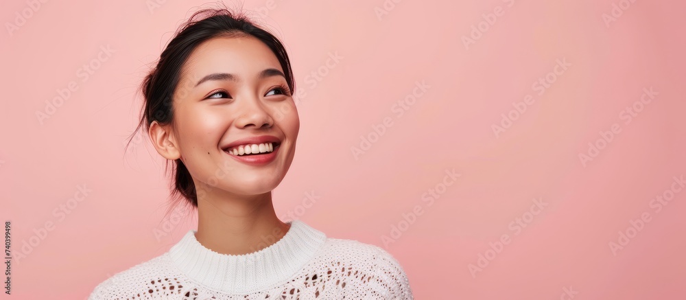 Wall mural Beautiful young woman posing in front of a vibrant pink background