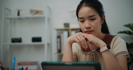 Selective focus, Front view, Female writer sitting at desk thinking idea holding pen making notes...