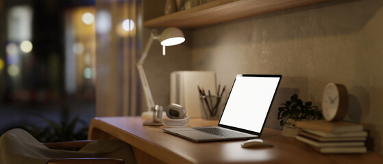 A minimal Scandinavian beige home office workspace at night with a laptop on a wooden table.