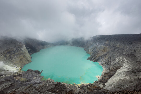 Scenic volcanic landscape and  Ijen volcano crater acidic lake in Java island