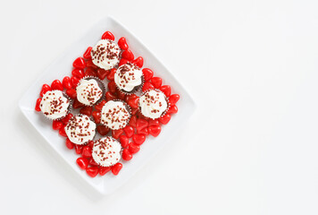 Mini Cupcakes with Red Candy Hearts on White Plate and Background