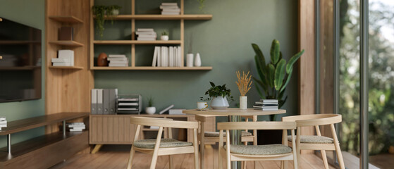 The interior design of a modern green office lounge or break room with a dining table and decor.