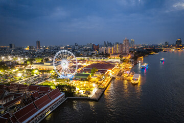 Fototapeta premium Aerial view of Asiatique The Riverfront open night market at the Chao Phraya river in Bangkok, Thailand
