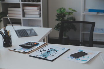 Financial analysts analyze business financial reports on a digital tablet planning investment project during a discussion at a meeting of corporate showing the results of their successful teamwork.