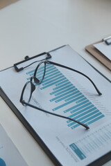 Financial analysts analyze business financial reports on a digital tablet planning investment...