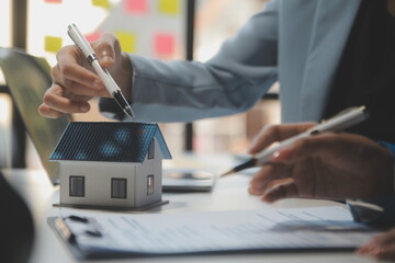 Real estate agent and customer signing contract to buy house, insurance or loan real estate.rent a house,get insurance or loan real estate or property. - obrazy, fototapety, plakaty