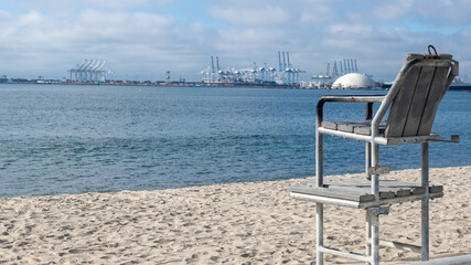 chair on a beach looking at industrial area