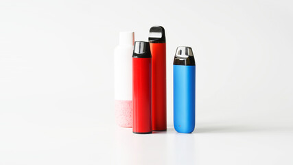 Four multicoloured electronic cigarettes on white background. Copy space. Photo