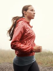 Nature, sports and woman athlete running on mountain road for race, marathon or competition training. Fitness, exercise and female person with cardio workout in misty outdoor woods or forest. - obrazy, fototapety, plakaty