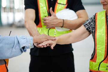 workers joining hands for cooperation success work and project in the factory