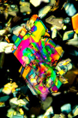 Abstract micrograph of colorful crystals of methionine in polarized light.