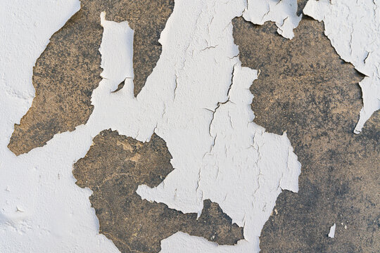 Grunge old concrete wall painted in white with cracks. Abstract texture, background