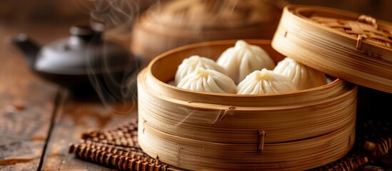 A bamboo steamer filled with dumplings sits on a wooden table, showcasing a traditional dish from various Asian cuisines like Khinkali, Momo, Buuz, and Xiaolongbao - obrazy, fototapety, plakaty