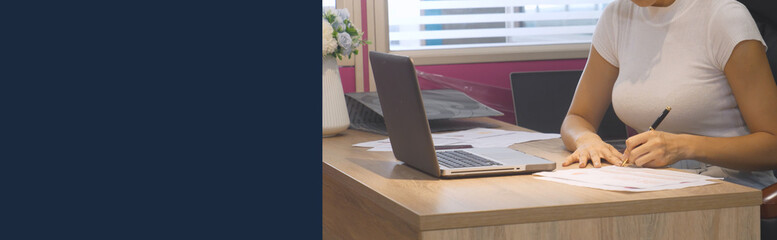 Banner Businesswoman hands type on laptop writing on notebook meeting at office desk. Banner Asian Woman Hands write planning office laptop. Female hand holding pen plan business with copy space