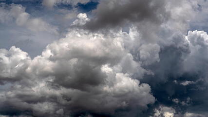 Obraz premium Dramatic dark storm rain clouds black sky background. Dark thunderstorm clouds rainny atmosphere. Meteorology danger windstorm disasters climate. Dark cloudscape storm disaster gloomy gray cloud sky